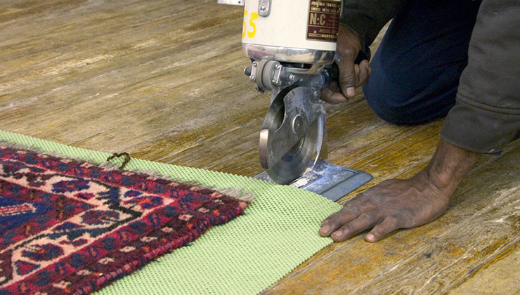 Photo of padding being cut for an area rug.